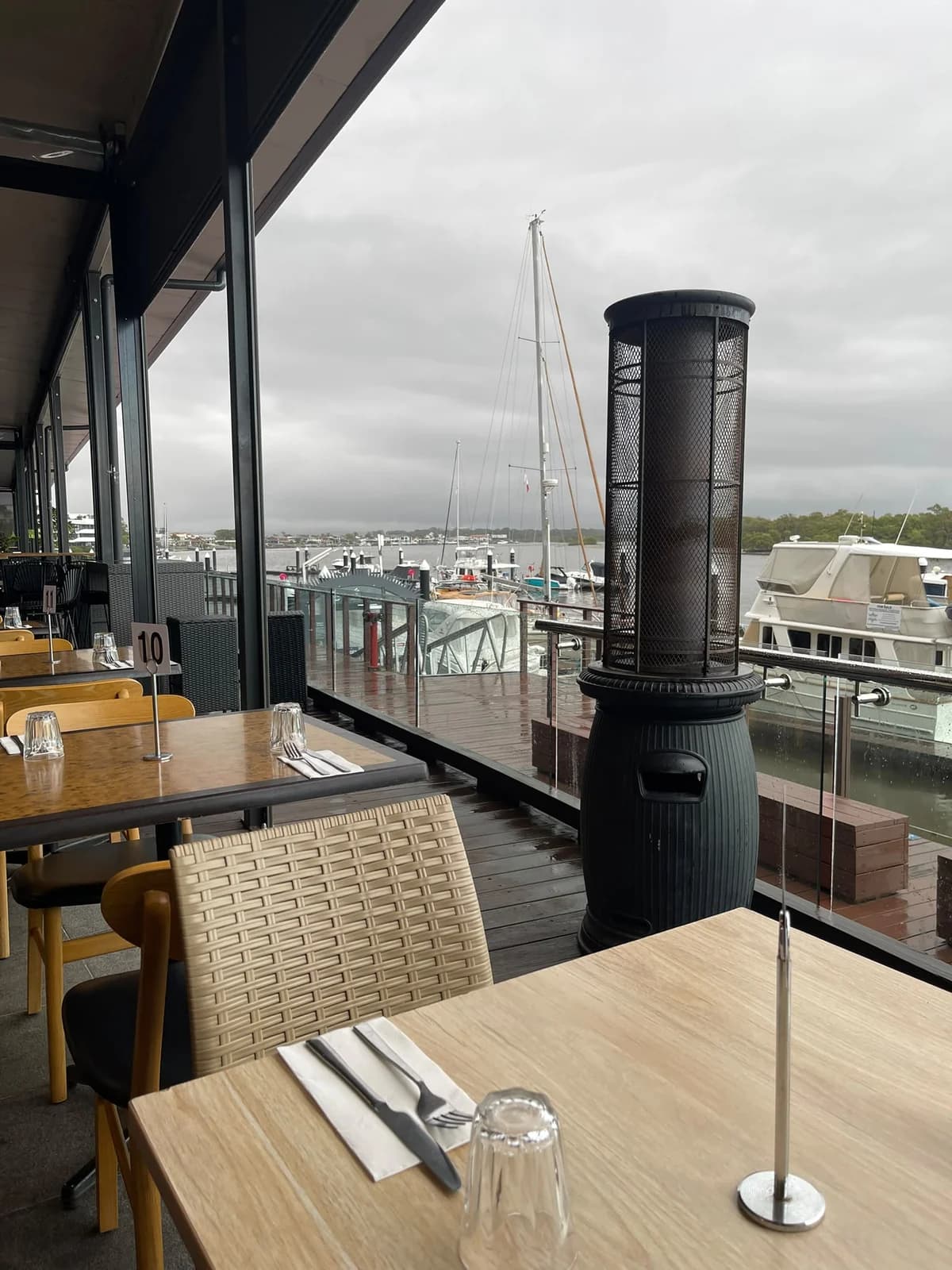 Tables beside the restaurant windows overlooking the marina